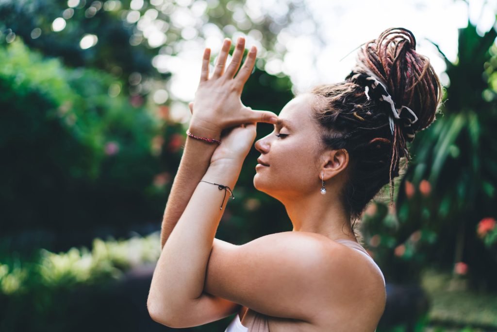 Woman doing yoga outdoor.
