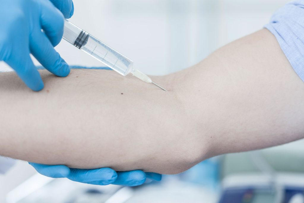 Doctor giving patient injection.