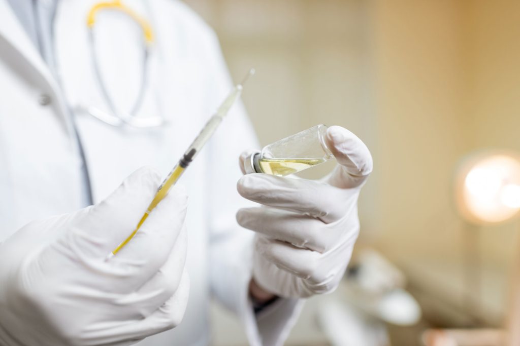 Doctor holding a vaccine.